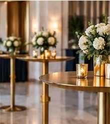 Elegant gold cocktail tables, cream florals, and candlelight at a contemporary event space