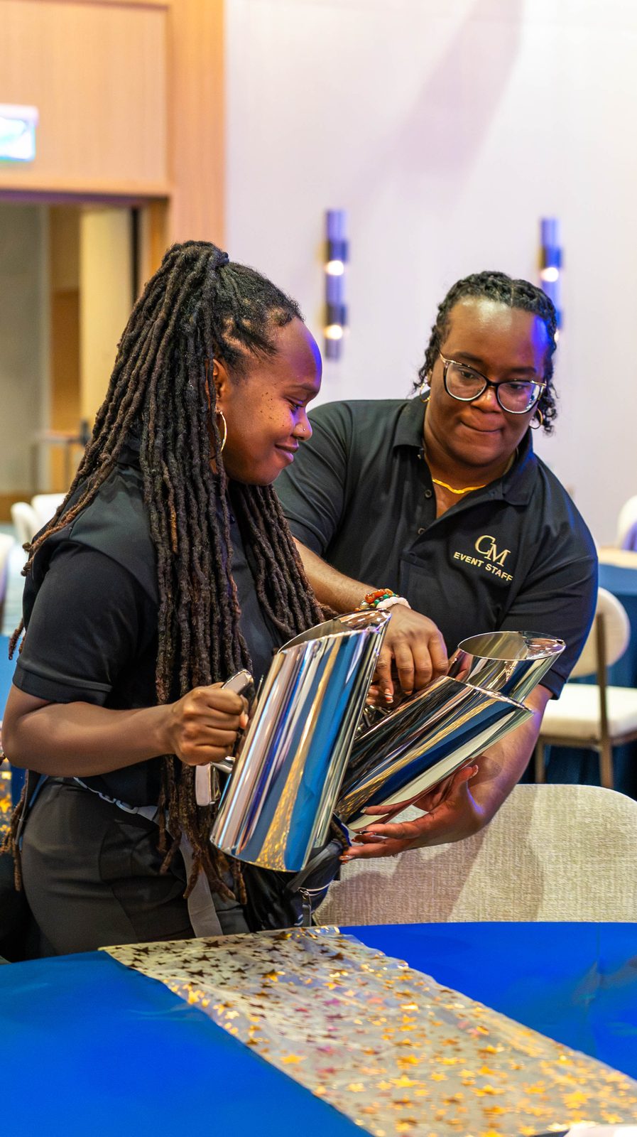 Creative Motion Events founder Fay and a teammate filling centerpiece cylinders during setup for the PMI Washington DC Chapter Awards Gala, JW Marriott Reston, Virginia