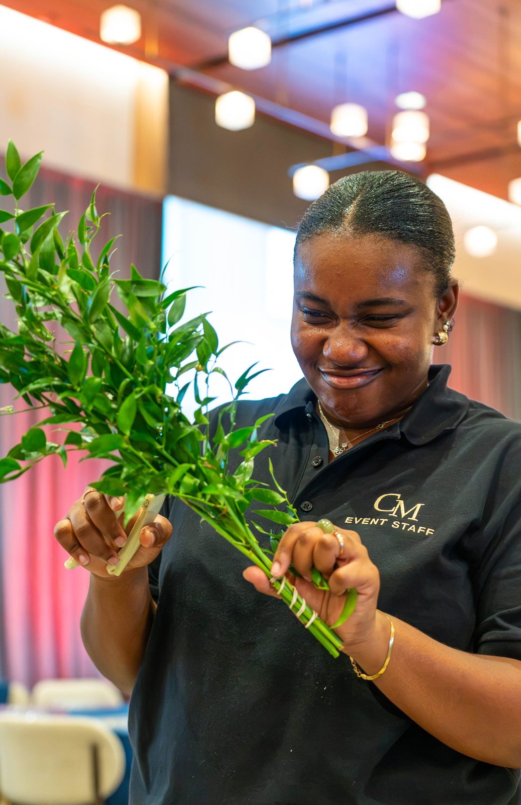 Creative Motion Events team member styling greenery for centerpieces at the PMI Washington DC Chapter Awards Gala, JW Marriott Reston, Virginia